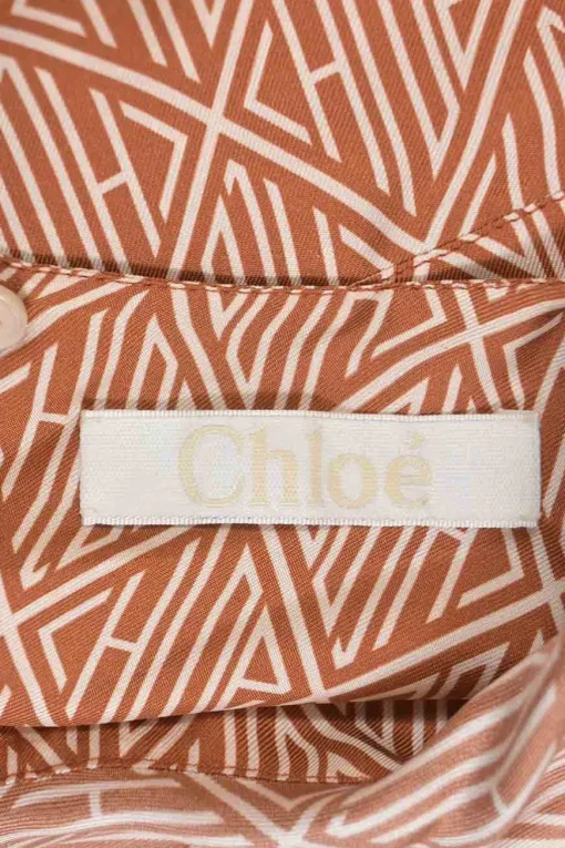 Sunset brown monogram print bateau neck foulard blouse with keyhole back