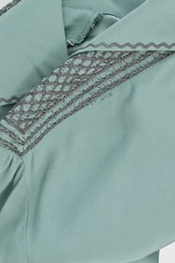 Turquoise silk symmetrical geometric pattern spread collar v-neck long sleeve gathered button cuff blouse with side concealed zipper