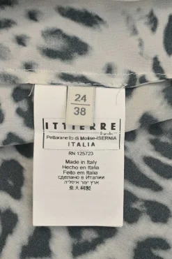 Two-tone silk leopard print cap sleeve blouse with coat of arms shank button appliqué at shoulder line