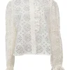 White broderie Anglaise peek-a-boo blouse with ruffled collar, flounce cuffs, and concealed placket