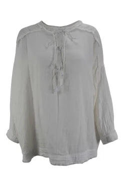 White cotton boho shirt with braided straps at the front and pockets on the sides. Adorned with embroidery and  fringes hem