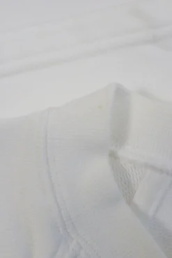White cotton jersey raglan sleeve cropped slogan t-shirt featuring foiled Coco Mark laurel wreath motif