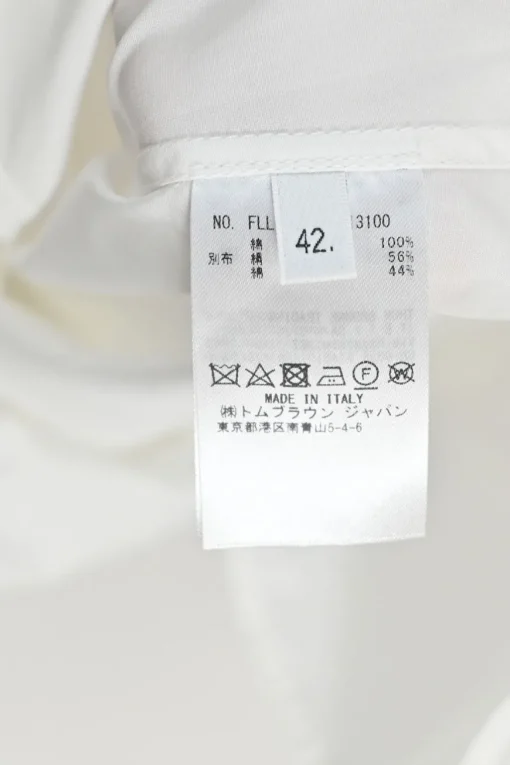 White cotton poplin bow tie collar button-front shirt with curved hem