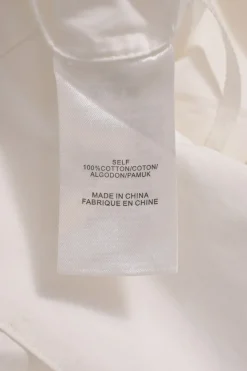 White cotton poplin foldover cold-shoulder button-front shirt
