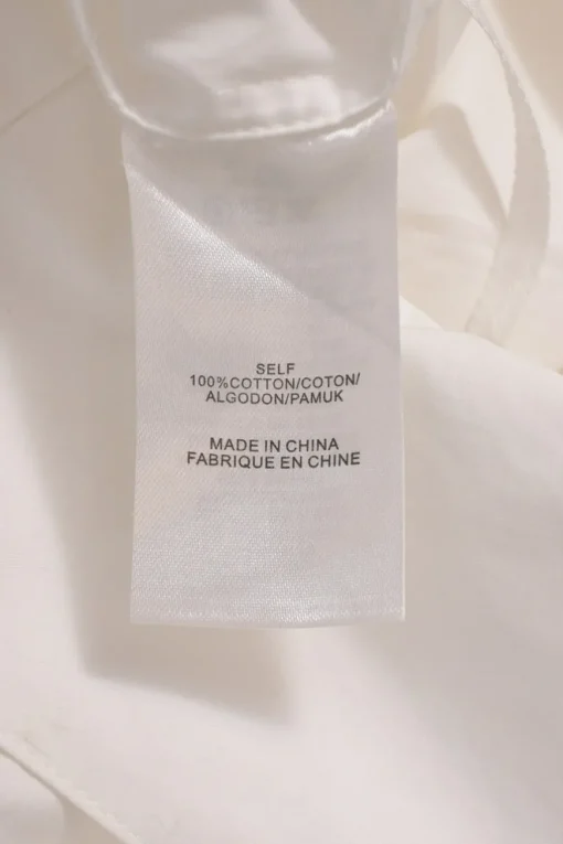 White cotton poplin foldover cold-shoulder button-front shirt