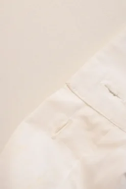 White cotton poplin high-collar button-front shirt featuring pintuck bib and gathered bishop sleeves
