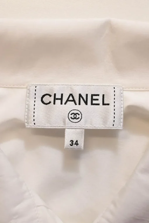 White cotton poplin high-collar button-front shirt featuring pintuck bib and gathered bishop sleeves