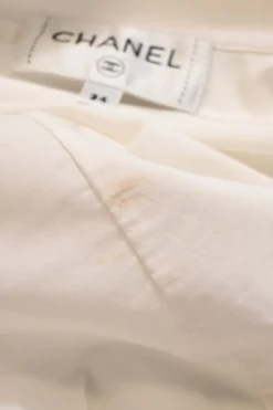 White cotton poplin high-collar button-front shirt featuring pintuck bib and gathered bishop sleeves