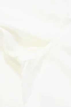 White cotton poplin Peter Pan collar button-up shirt with ruffled hem