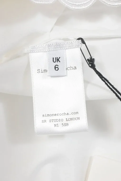 White cotton poplin point collar button-front shirt featuring tonal scalloped broderie trim inserts