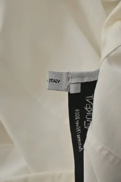 White cotton poplin single breasted notch lapel plunge neck blouse with flutter sleeve appliqué