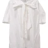 White cotton poplin tie-neck puff sleeve swing-style blouse with concealed button placket