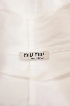 White cotton poplin tie-neck puff sleeve swing-style blouse with concealed button placket