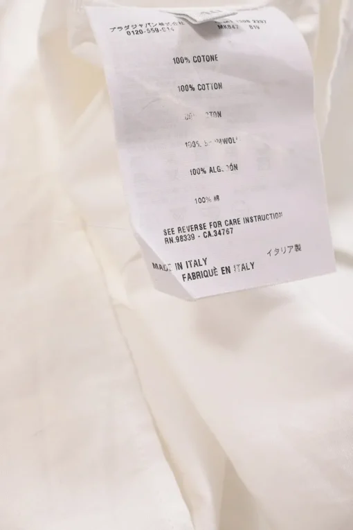 White cotton poplin tie-neck puff sleeve swing-style blouse with concealed button placket