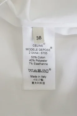 White cotton-blend pullover shirt with classic collar, button cuffs, and round hem