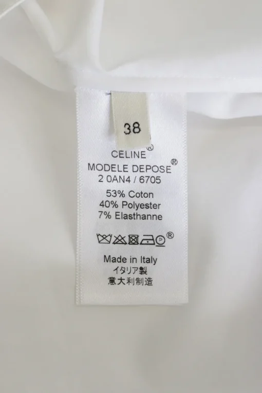 White cotton-blend pullover shirt with classic collar, button cuffs, and round hem