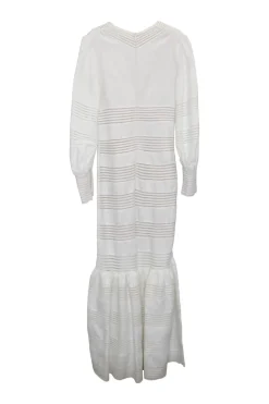 White crochet-trimmed linen plunge neck maxi dress with bishop sleeves and flounce hem