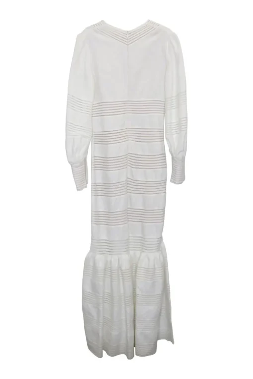 White crochet-trimmed linen plunge neck maxi dress with bishop sleeves and flounce hem