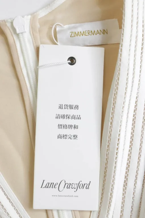White crochet-trimmed linen plunge neck maxi dress with bishop sleeves and flounce hem