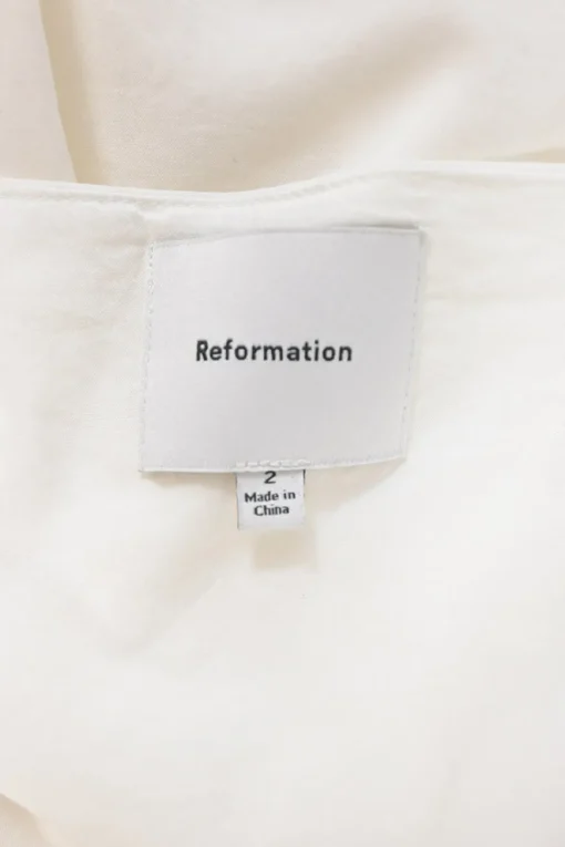 White draped organic cotton-blend twist-front strapless sheath dress
