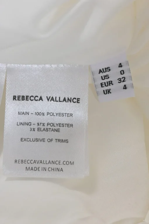 White embellished polyester Delaney sleeveless bridal mini dress featuring bead broderie motif along collar, bodice, and darted waist