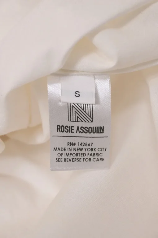 White frill-trimmed polyester cold-shoulder swing-style shirt with exposed button placket and high-low hem