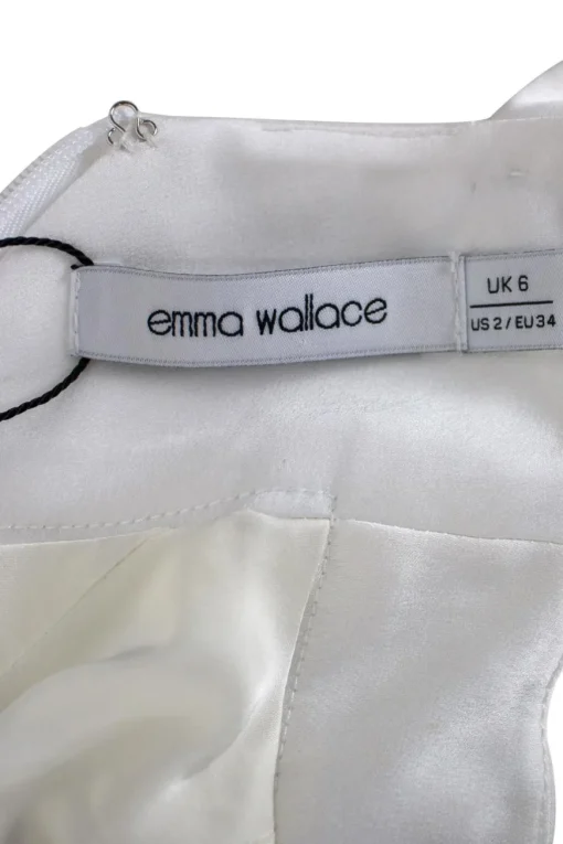 White halter-neck maxi-dress with tie-neck closure and oversized snap embellishments