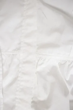 White long-sleeved top with pleated hem