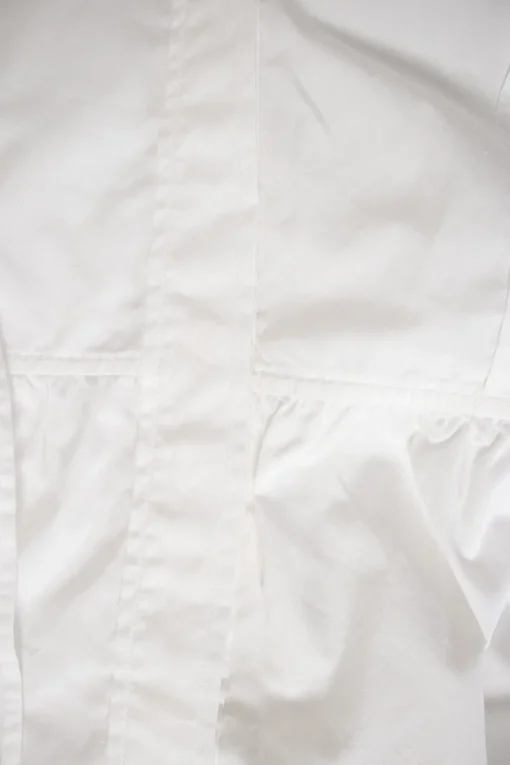 White long-sleeved top with pleated hem