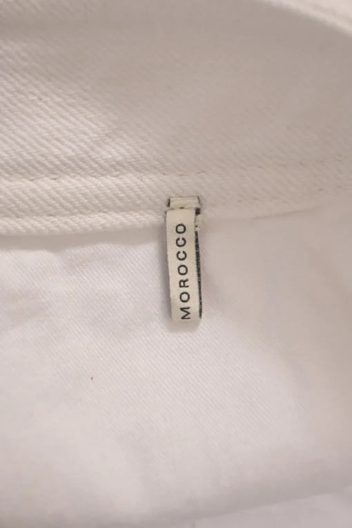 White low-rise Caly zip-up mini skirt with extended tab closure and exposed zip slanted pockets