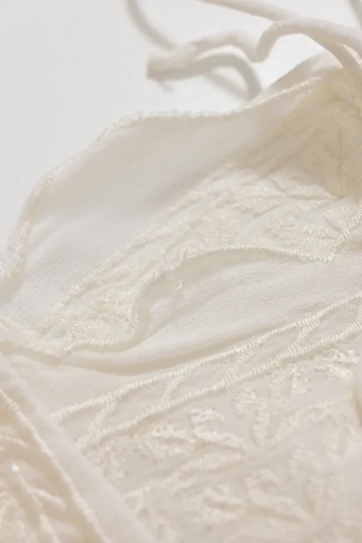 White paneled viscose flutter sleeve bateau neck blouse with scalloped edges