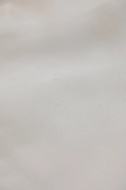 White paneled viscose flutter sleeve bateau neck blouse with scalloped edges