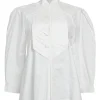 White shirtwaist-style stand collar button-front peplum blouse with pintuck bib and raglan sleeves