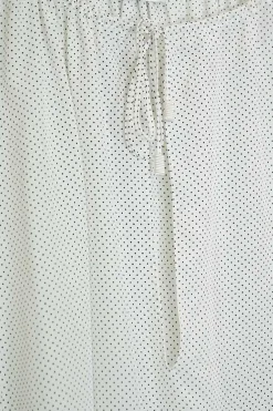 White silk chiffon polka dot print pullover tie-front tunic top with gathered neckline and blouson sleeves