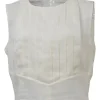 White sleeveless knife-pleat bib blouse with Coco Mark shank button keyhole back