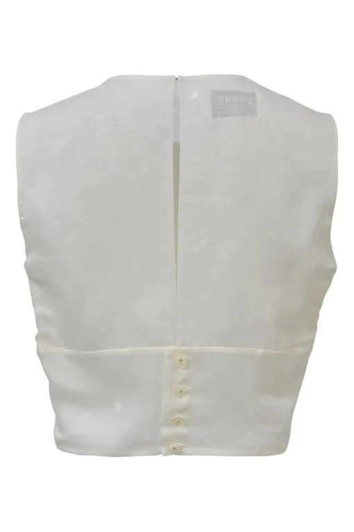 White sleeveless knife-pleat bib blouse with Coco Mark shank button keyhole back