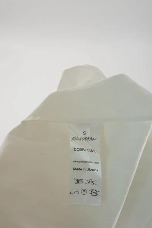 White stretch cotton poplin cold shoulder ruffle swing blouse with bell sleeves