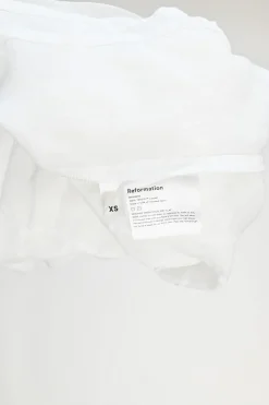 White Tencel button-front puff sleeve ruffle peplum top with cinched waist