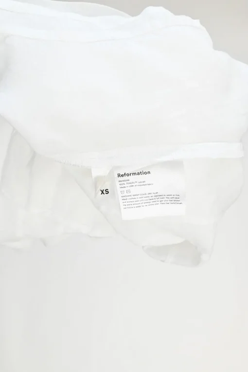 White Tencel button-front puff sleeve ruffle peplum top with cinched waist