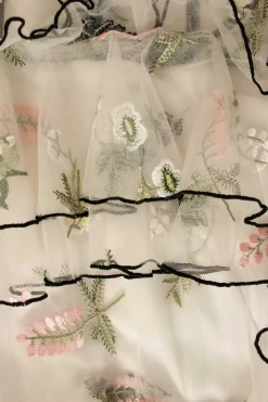 White tulle tiered ruffle maxi strap dress featuring floral embroidery in pastel colour and black trim