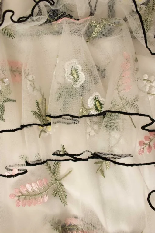 White tulle tiered ruffle maxi strap dress featuring floral embroidery in pastel colour and black trim