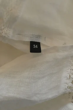 White voile Edwardian combination-style band collar half-button pintuck tunic blouse with tonal lace inserts