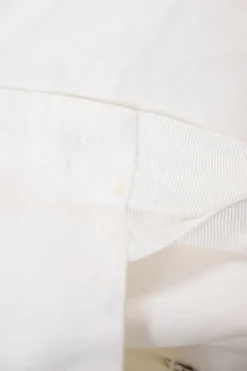White wrap-front apron-style mini skirt with adjustable self-tie fastening at waist