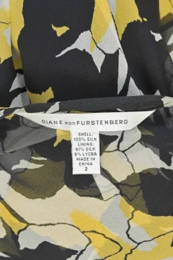 Yellow and black semi-sheer silk floral print long sleeve wrap A-line dress with tie-cuff sleeves