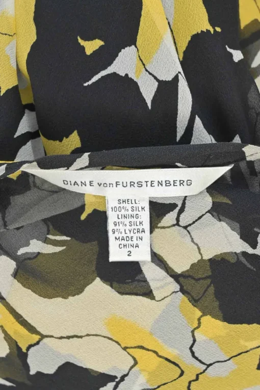 Yellow and black semi-sheer silk floral print long sleeve wrap A-line dress with tie-cuff sleeves