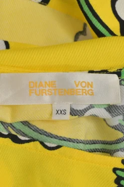 Yellow bias-cut rayon-blend graphic floral print bateau neck cap sleeve handkerchief blouse