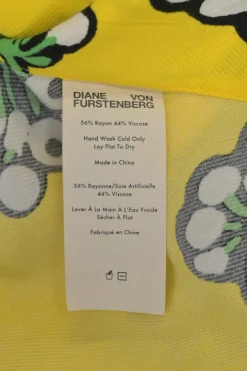 Yellow bias-cut rayon-blend graphic floral print bateau neck cap sleeve handkerchief blouse