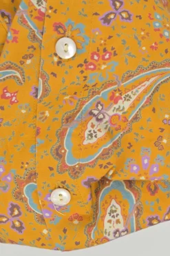 Yellow cotton voile paisley print button-front collarless long sleeve blouse