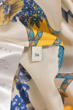 Yellow Intrigue-print silk kimono shirt with flap collar and tassel motif