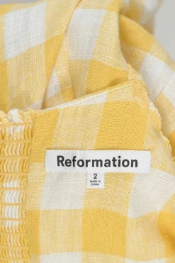 Yellow linen gingham puff sleeve sun dress with cutout at centre front